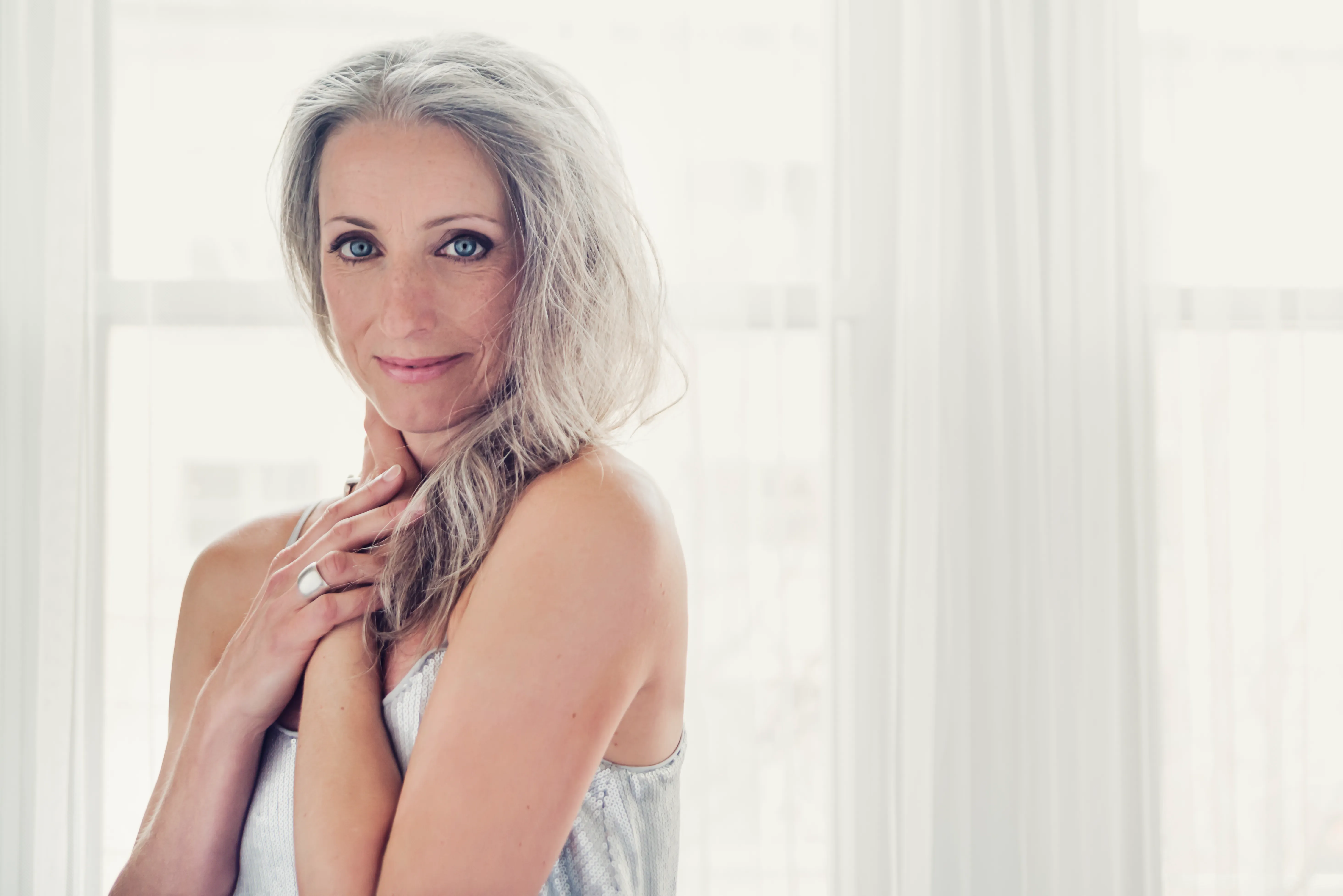 Smiling woman in her 50s, age 51, in casual attire
